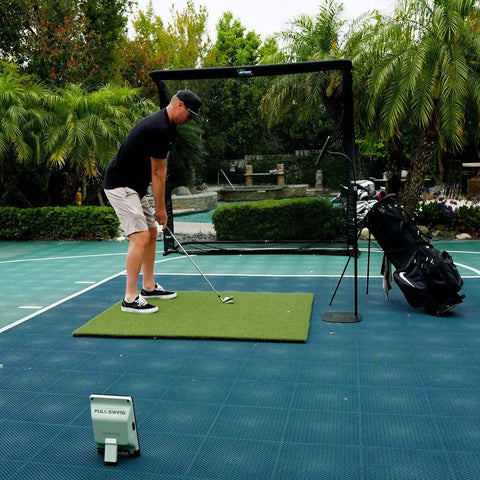 Person using Golf Launch Monitor And Simulator Kit With 16 Data Points And 5D AI Radar, The Net Return Pro Net, on outdoor court