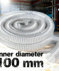 Clear 100mm PVC Bellows Hose For Dust Extraction In The Shop Flexible Corrugated Design Lets You Bend At Any Angle Without Collapsing Or Blocking Airflow See Through Material Reveals Dust Build Up And Keeps Your System Flowing. coiled 100 mm clear PVC bellows hose, inner diameter 100 mm, for shop dust extraction