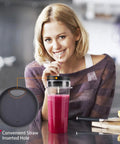 Smiling woman using Replacement 16 Oz Blender Cup Set with straw in pink smoothie, highlighting straw hole detail.