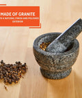 Compact Granite Mortar and Pestle 3.75 Inch Bowl for Spices and Herbs displayed with spices on wooden counter