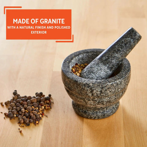 Compact Granite Mortar and Pestle 3.75 Inch Bowl for Spices and Herbs displayed with spices on wooden counter