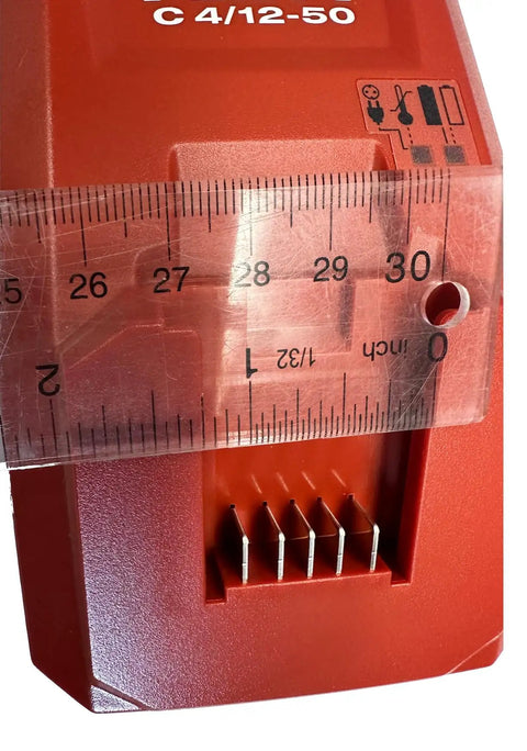 Close-up of C 4/12 50 Battery Charger for Cordless Systems 110V Black showing charging pins and size comparison with ruler.