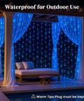 Outdoor setup with blue 300 LED Fairy Curtain Lights with waterproof waterfall glow, 9.8 feet by 9.8 feet, 10 vertical strands