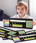 Child holding Huge 48 Pack Chalkboard Style Self Adhesive Desktop Nameplates For Classroom Use with educational charts.