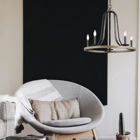 Conal Five Light Chandelier in Stardust Finish above modern living room chair.