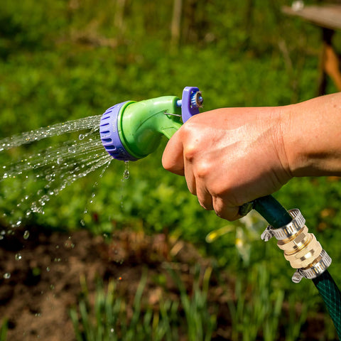 Hand holding green hose fixed with Garden Hose Repair Connector Kit With Clamps For 3/4 Or 5/8 Inch Hoses Male And Female Adapters