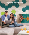 Couple enjoying time on sofa with 12 Pack Turquoise Hexagon Acoustic Panels High Density Foam Wall Tiles for sound dampening.
