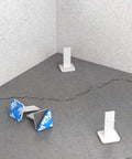 Model 82 289 Leveling Pins 50 Pack For Concrete Pours With Self Adhesive Backing shown on a cracked concrete surface