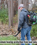 Person using a leaf blower in forest, demonstrating Maximum Noise Blocking Soft Foam Earplugs 50 Pairs With 33 dB NRR For Sleep Snoring.