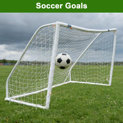 Soccer ball in motion hitting a white goal net against a grassy field.