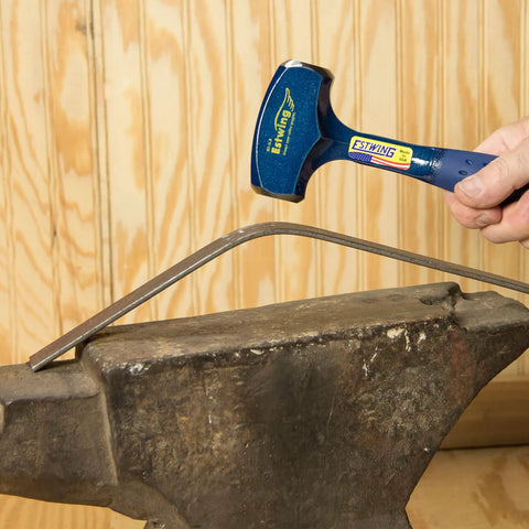 3 Pound Drilling And Crack Sledge Hammer in use on an anvil, showcasing forged steel construction and shock reduction grip.