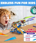 Boy playing with 2in1 Hydraulic Paper Airplanes and Darts Launcher STEM Toy for Kids Ages 6 to 14 Easy DIY Build Kit on table.