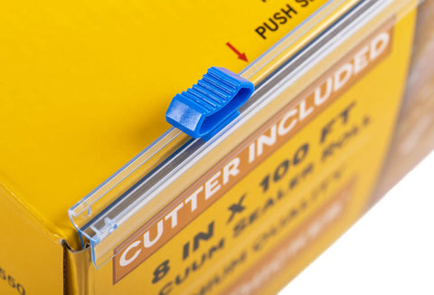 Close-up of the built-in cutter of 11 Inch By 100 Foot Vacuum Sealer Bags Rolls With Dispenser Cutter in a yellow box