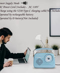 Grab N Go Portable AM FM Shortwave Radio Bluetooth Speaker With Four Power Modes on desk next to laptop and plant