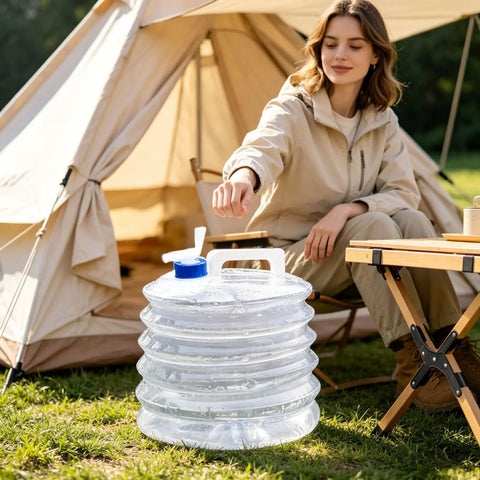 Person camping with 10L Collapsible Water Container With Spigot For Camping And Hiking next to a tent and table