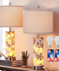 27.5 Inch Coastal Glass Table Lamps Set Of 2 With Seashells And Fairy Lights, 3 Way Dimmable Touch Lamps With USB Ports For That Chill Bedside Vibe, Bulbs Included, shown lit on a bedside table with charging phones