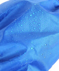 Close-up of blue waterproof nylon fabric with water droplets on Adjustable Nylon Snow Gaiters For Men And Women.