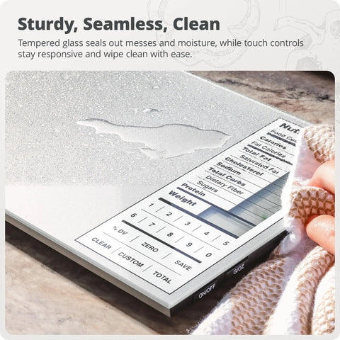 Meal-Prep Go-To Food Scale With Built-In Nutrition Calculator No App Needed 2000 Preloaded Food Codes Compact Battery-Operated Kitchen Scale 11 Lb Capacity Ideal For Weight Loss And Healthy Cooking Silver showing close-up of seamless tempered glass surface with water droplets and visible control panel.