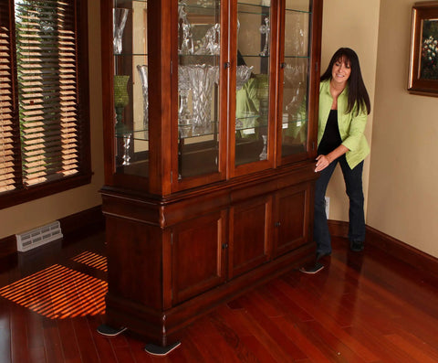 Woman using Heavy Duty Furniture Sliders For Hardwood Tile Luxury Vinyl And Other Hard Surfaces Glide Smoothly And Protect Floors Move Heavy Stuff Easy 8 Inch Long By 5 Inch Wide Four Slide Set Built To Last For Pros And Home Use under cabinet