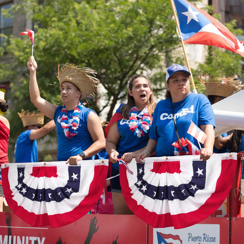Group with All American Patriotic Bunting Banner Pack With A 4 Pack Of Red White And Blue Half Fan Flags in a parade setting