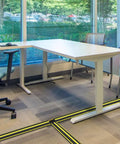 Office with 10 Foot Floor Cable Cover Protector Pro Grade Heavy Duty PVC Duct Easy To Unroll And Route Cables, preventing trip hazards.