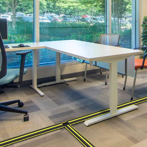 Office with 10 Foot Floor Cable Cover Protector Pro Grade Heavy Duty PVC Duct Easy To Unroll And Route Cables, preventing trip hazards.