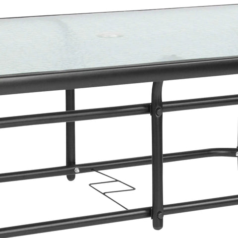 Close-up of black metal frame and rippled glass top of Modern Rippled Glass Outdoor Dining Table With Umbrella Hole.