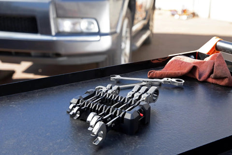 Seven Piece Flex Head Ratcheting Wrench Set 12 Point SAE Tough As Nails Tools for Tight Spots on workbench near car