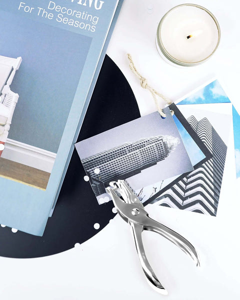 Circle Hole Punch Set Two Piece One Eighth Inch And One Quarter Inch Single Hole Punchers for crafts next to photos and candle