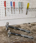 Two hammers from Six Piece Hammer Set For Metalworking: Forging, Pein, And Sledge Hammers, Rugged Hand Tools on workbench.