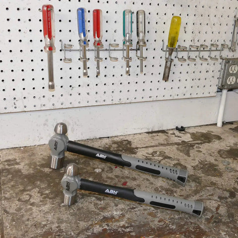 Two hammers from Six Piece Hammer Set For Metalworking: Forging, Pein, And Sledge Hammers, Rugged Hand Tools on workbench.