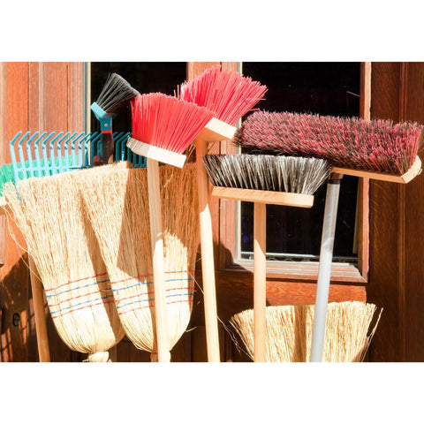 Ten Pack Wall Mount Organizing Spring Clamps For Tools, Rakes And Brooms holding various brooms and rakes against a wall.