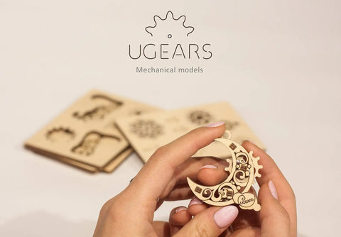 Fidget Tribiks Self Assembly Kit For Stress Relief And Fun Four Mini Wooden Mechanical Gear Models Easy Snap Off Parts Family Friendly STEM Toy For Adults And Kids 5 Plus Premium Wooden Construction moon-shaped wooden gear model held in hands