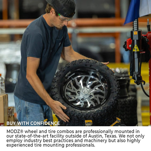 Man mounting Sick Glossy White Steel Golf Cart Wheels And Durable Turf Replacement Tires Set Of Four in workshop.