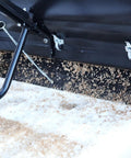 Close-up of Spyker P70-12010 Commercial Drop Spreader dispensing on snow, showing powder-coated steel frame and precision spreader.