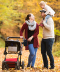 Family in a park with a stroller featuring Universal Stroller Cup Holder With Phone Holder, adjustable drink holder attached.