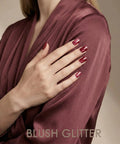 Close-up of hands with Semi Cured Gel Nail Strips Real Gel Polish UV Wraps For Brittle Nails, glitter cat eye hot pink.