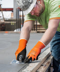 Person wearing Waterproof Work Gloves for Men and Women, Double Latex Coated, Non Slip Grip, Size Large, working on construction.