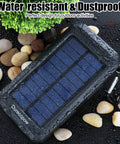 Rugged 8000mAh Solar Charger Power Bank For Outdoor Adventures, Grab And Go Portable Waterproof Camping Backup Battery Pack displayed outdoors