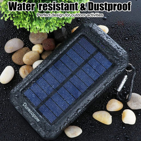 Rugged 8000mAh Solar Charger Power Bank For Outdoor Adventures, Grab And Go Portable Waterproof Camping Backup Battery Pack displayed outdoors
