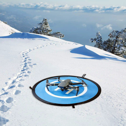 Waterproof Portable Foldable Helipad Landing Mat For Drones 22 Inch 55cm on snowy terrain with DJI drone, outdoor use.