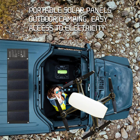 Road Trip Ready No Sweat Foldable Solar Panel 42W Portable Charger waterproof on top of vehicle while camping.