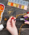 Using 4 Piece Jewelry Pliers Set For Beading And Jewelry Making Including Needle Nose Pliers, Round Nose Pliers, Bent Nose Pliers And Wire Cutter Handy Tools Kit For Bracelet Craft, Wire Wrapping, And DIY Jewelry on a heart-shaped bead with chain and bead organizer visible.