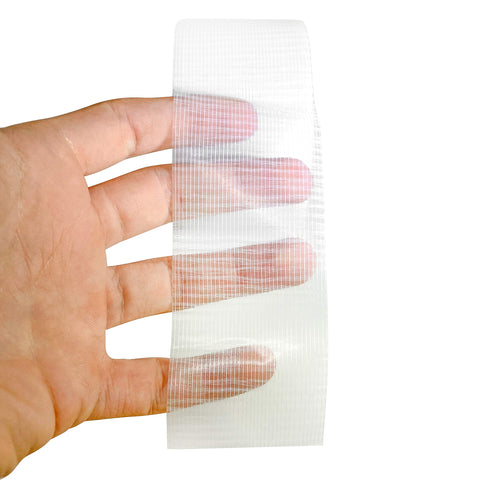 Kickass Heavy Duty Clear Duct Tape 2 Inch By 30 Yard Roll held in hand, showcasing woven backing and transparency for repairs.