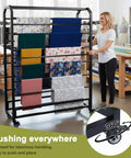 Heavy Duty Commercial Fabric Roll Storage Rack With 16 Adjustable Hanging Rods, showcasing colorful fabric rolls in a creative studio.