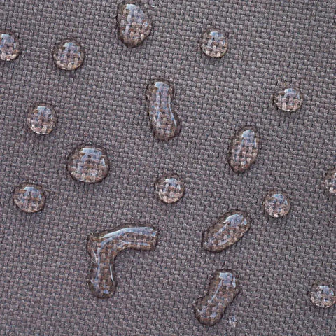 Close-up of water droplets on Ultimate Waterproof 34 Inch Round Fire Pit Cover For Outdoor Patios showing waterproof material.