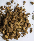 Decomposed Granite For Pathways And Patios, Compactable DG Gravel For Trails And Paver Bases with a quarter for scale
