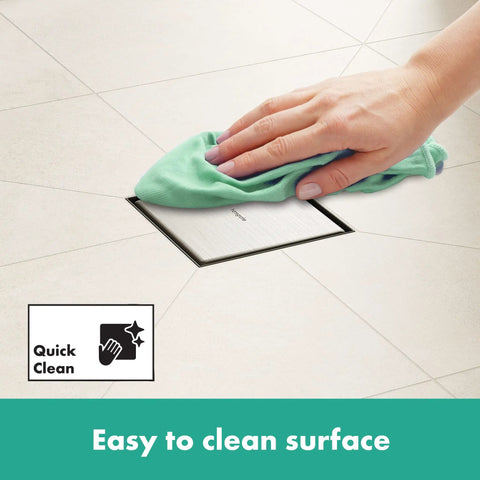 Square Tileable Shower Drain Set With Brushed Stainless Steel Construction And Flush Floor Mount Design For Modern Bathrooms being cleaned with a cloth.