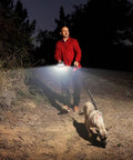 Person walking dog at night with Dope Rechargeable LED Flashlight With 180 Degree Wide Beam, 1000 Lumens in hand.