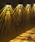 Halloween Solar Deck Lights Outdoor Waterproof LED Garden Decor 4 Pack illuminating wooden wall with warm glow